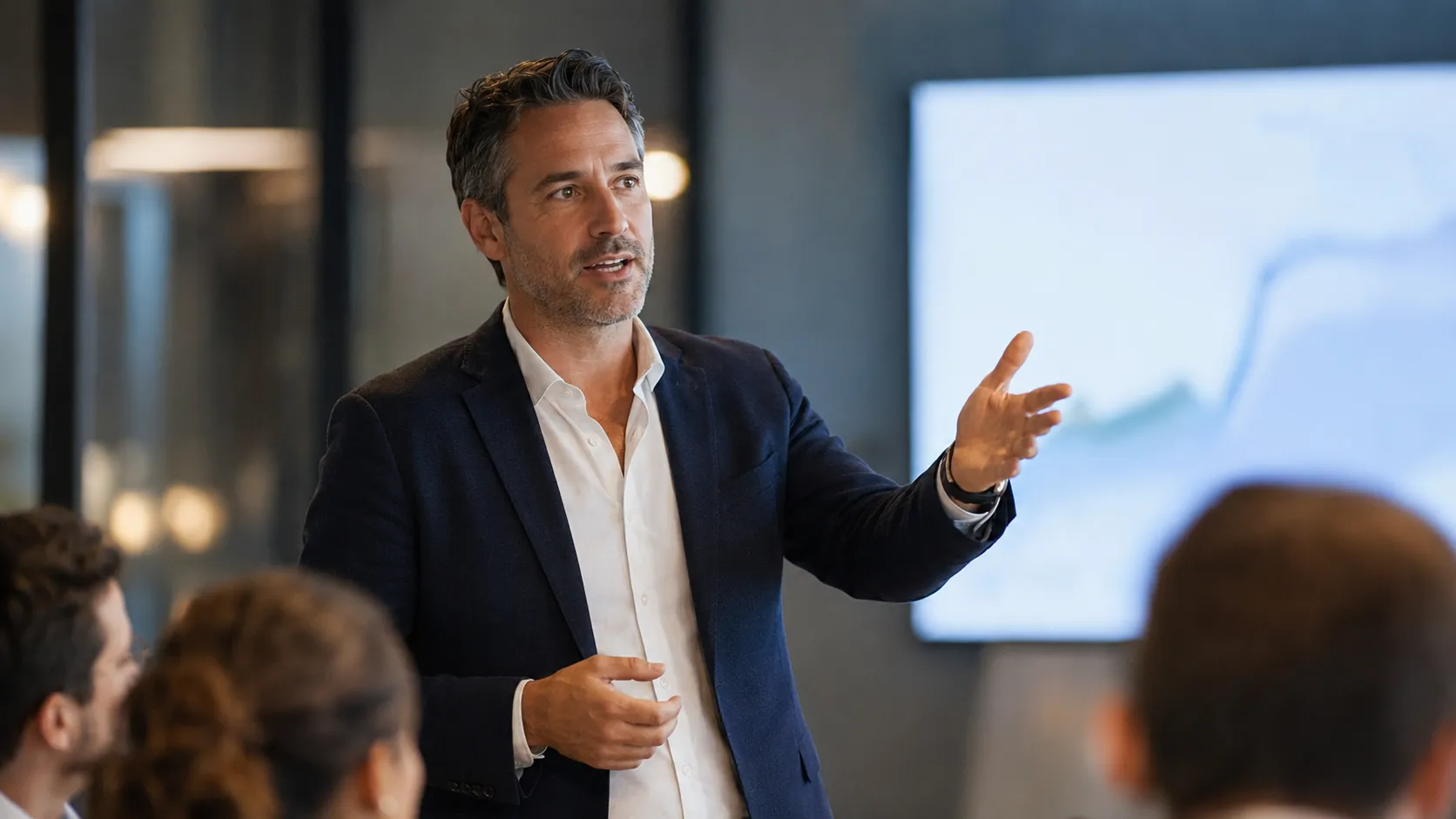 A man presenting to colleagues in a meeting room